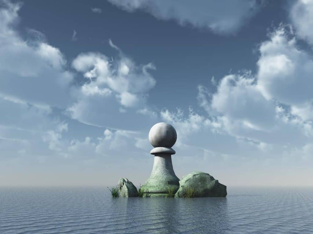 A chess pawn in the ocean against a dramatic, cloudy sky.